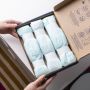Image of someone holding an open box of Twist & Click refills on a changing table